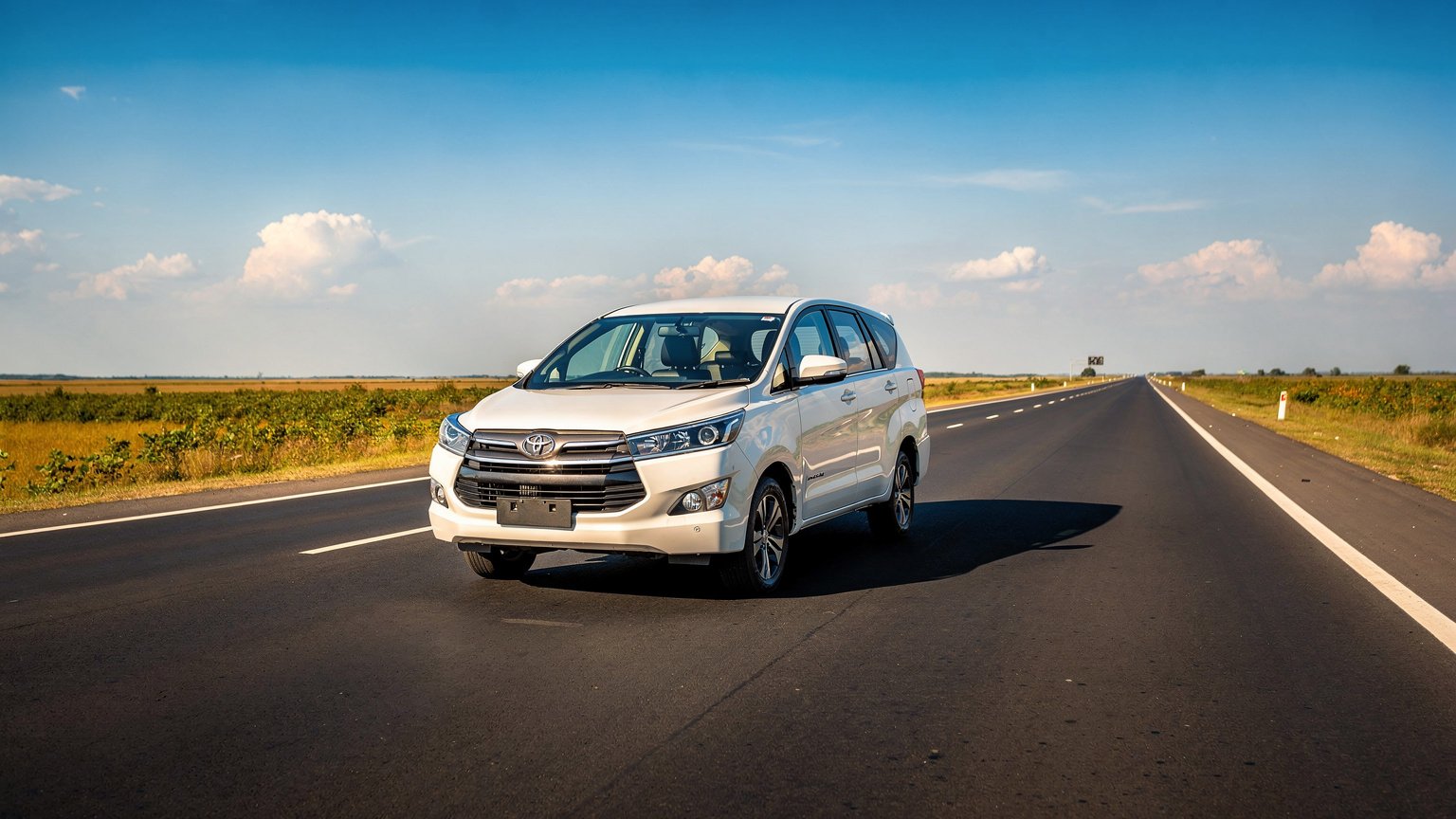 White MPV taxi on an open highway under a blue sky (illustrative image)