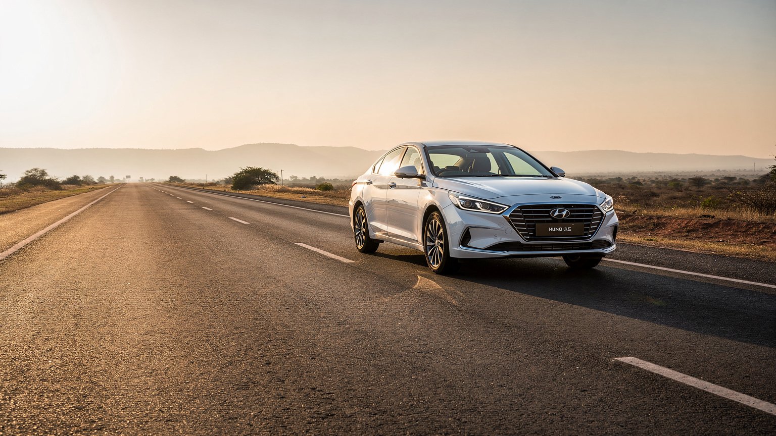 White sedan on a long open highway at golden hour (illustrative image)