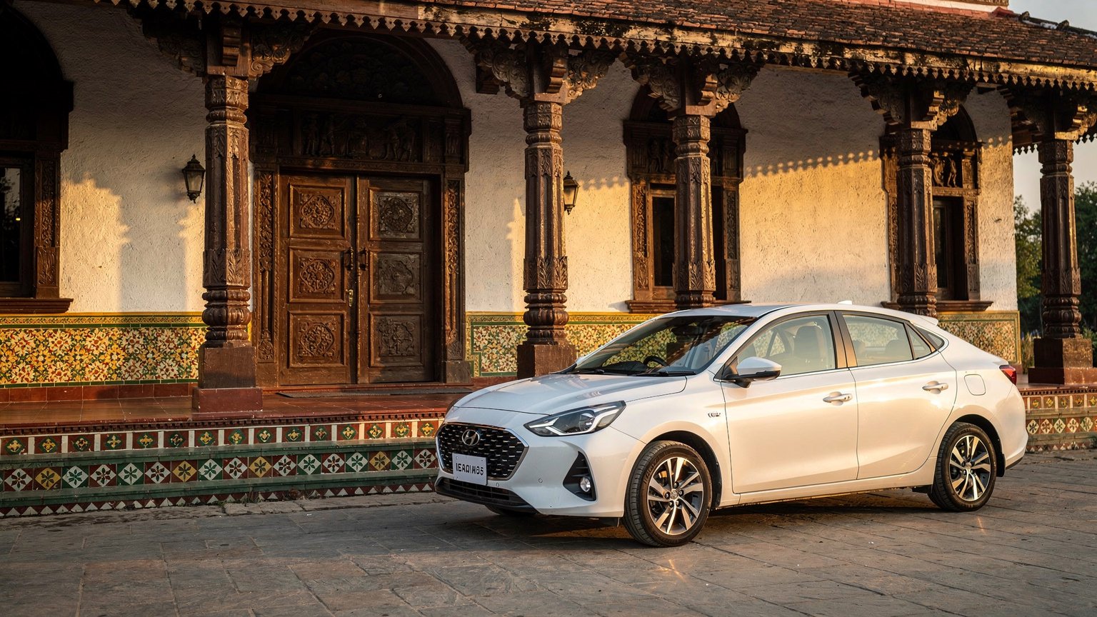 White sedan outside a Chettinad-style mansion (illustrative image)