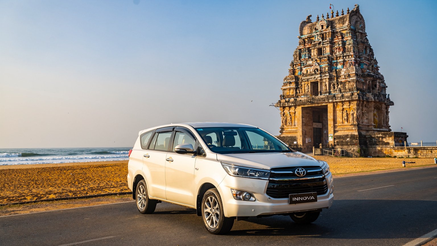 White MPV taxi near a seashore temple in Tamil Nadu (illustrative image)