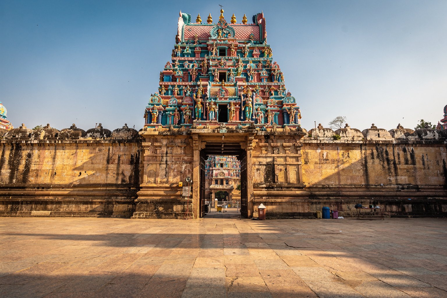 South Indian temple gateway towers against a blue sky (illustrative image)