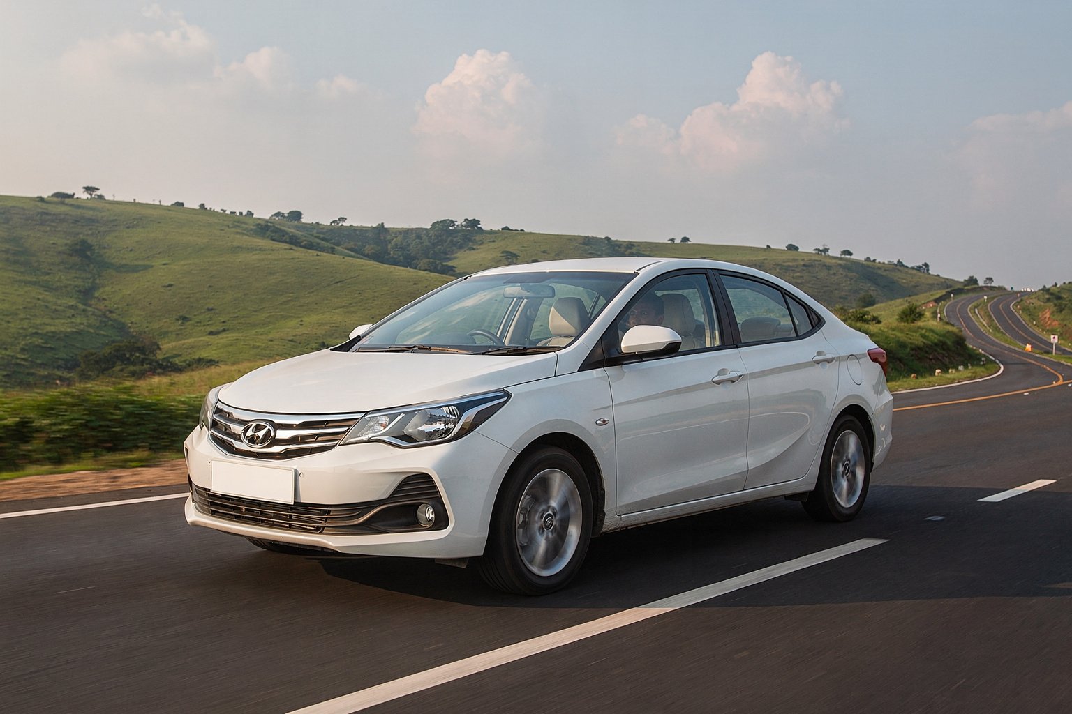 White sedan on an open highway through green hills (illustrative image)